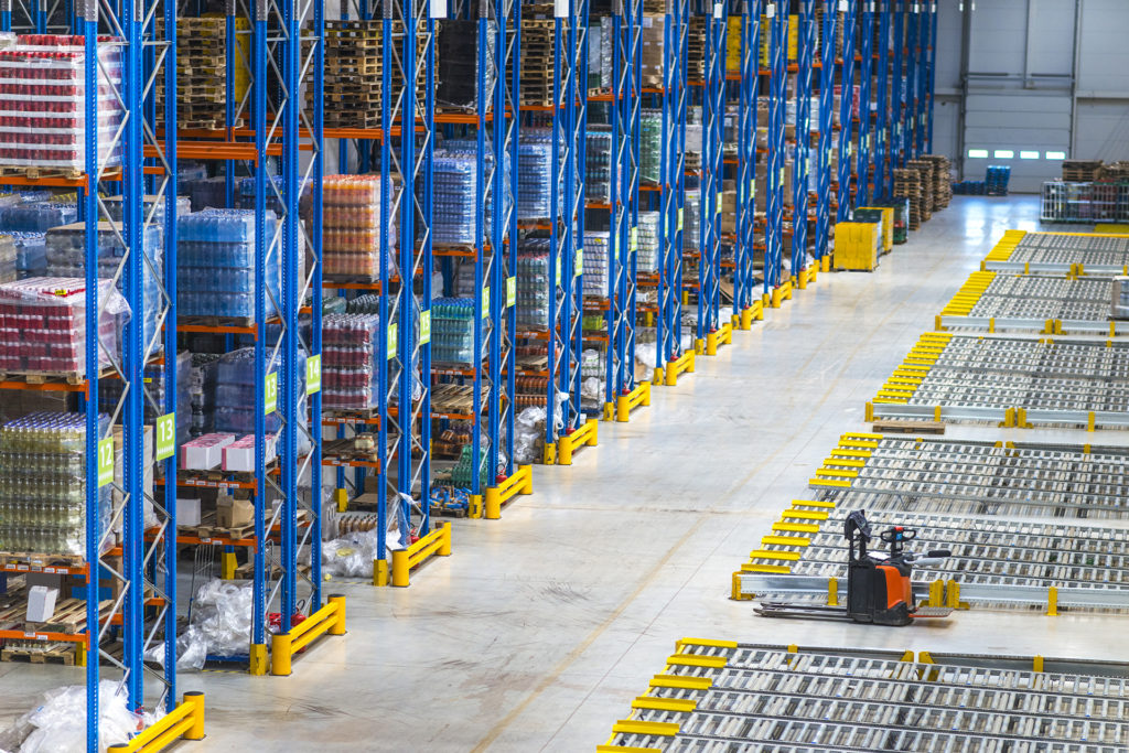 Distribution warehouse building interior and large storage area with goods on the shelf.